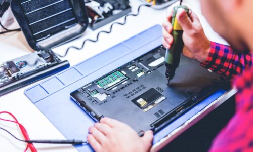 man-repairing-laptop-at-workplace