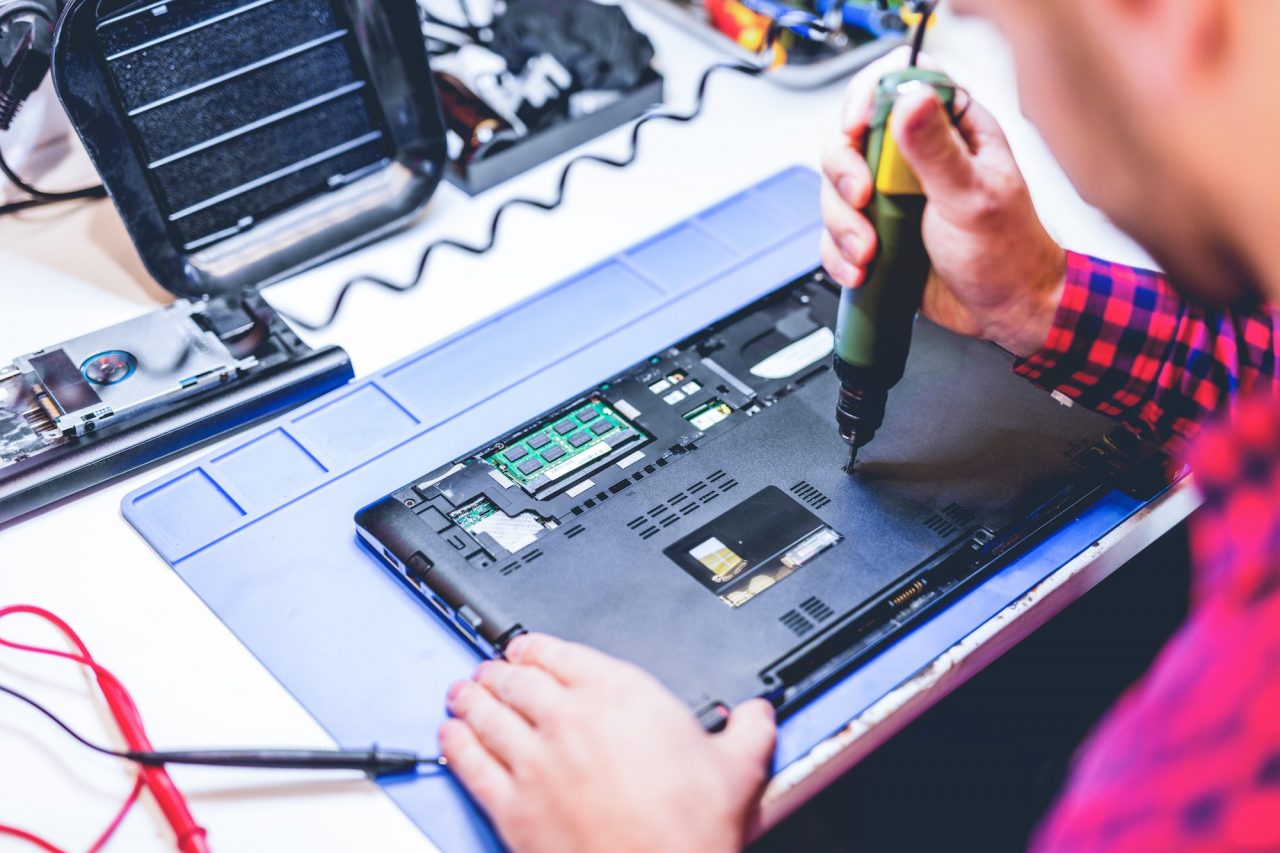man-repairing-laptop-at-workplace